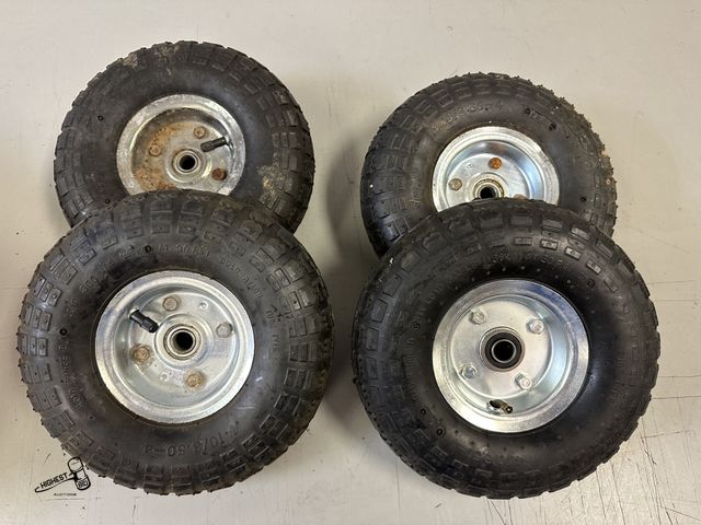 Lot 91-10268 - 4 - 4.10/3.50-4 RUBBER TIRES ON RIMS WITH BEARINGS FOR 5/8" SHAFT SIZE MULTI PURPOSE