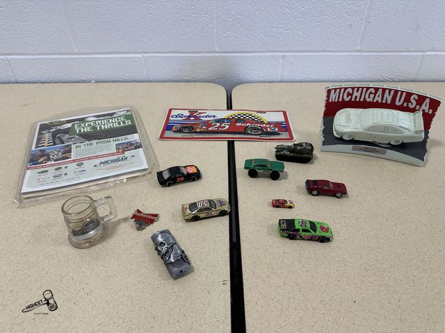 Lot 91-7002 - MICHIGAN INTERNATIONAL SPEEDWAY COLLECTIBLES AND SOME HOTWHEELS WITH A DAYTONA SHOT GLASS AND A KEN ...