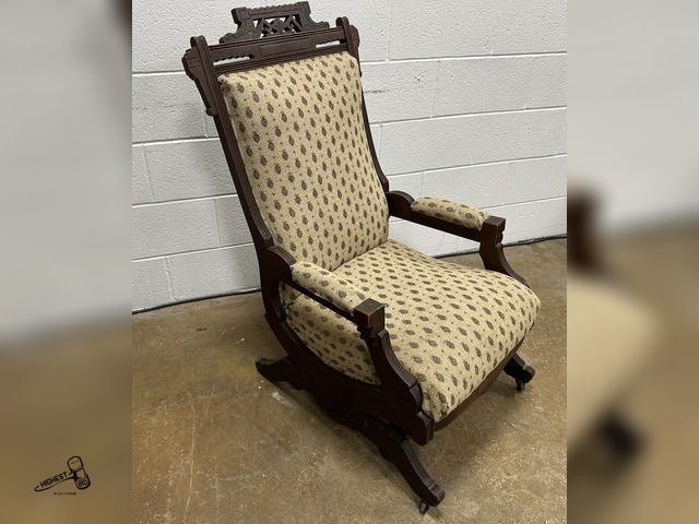 Lot 91-9037 - AUNTIQUE EASTLAKE VICTORIAN PLATFORM ROCKER WITH PATTERNED UPHOLSTERY &amp; METAL CASTERS ON FRONT L...