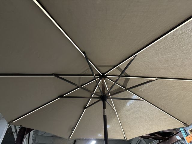 Lot 91-8819 - SUNVILLA 10' LED MARKET KHAKI UMBRELLA WITH BATTERY AND SOLAR CHARGER