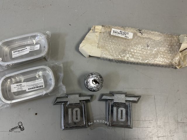Lot 91-8234 - VINTAGE CAR PARTS - CHEVY C 10 EMBLEMS- LOCKING GAS CAP - CLEAR DASH LENSE - GEAR INDICATOR - 60-66 ...