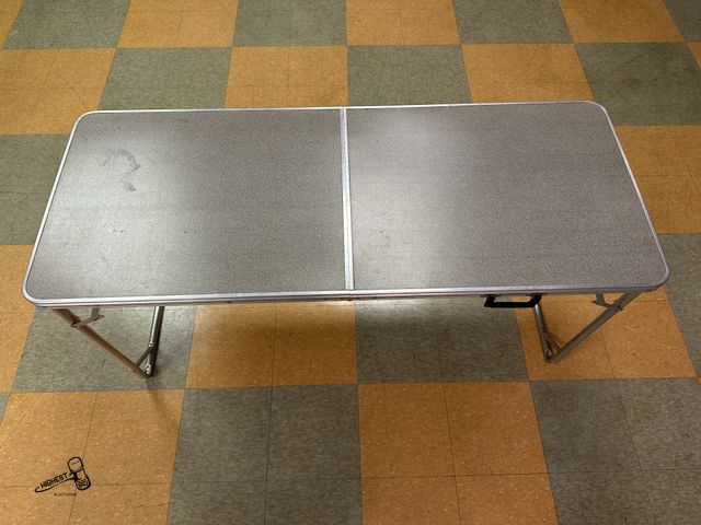 Lot 91-6915 - FOLDABLE ALUMINUM FRAME TABLE 2FT X 5FT - GREAT FOR HOLIDAY PARTIES