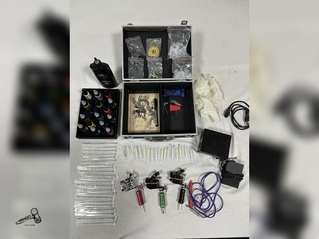 Lot 91-7670 - TATTOOING KIT - 3 COIL GUNS - MACHINE CORDS AND FOOT PEDAL - 22 NEEDLES - 16 ASSORTED COLORS - TATTO...