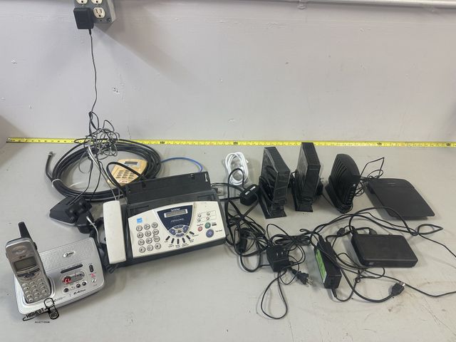 Lot 91-7548 - ELECTRONICS LOT - ROUTERS AND FAX MACHINE - HOME PHONE WITH ANSWER MACHINE - MISC BATTERYS