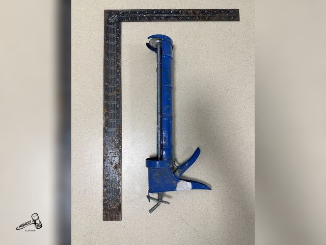 Lot 91-7112 - STEEL FRAMING SQUARE AND A METAL LARGE TUBE CAULK GUN