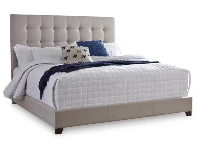 Lot 96-165826 - Signature DESIGN BY ASHLEY
Dolante Beige Wood Frame Queen Panel Bed with Button Tufting
MSRP $309.25...