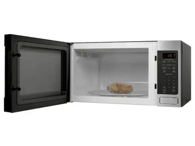 Lot 96-227357 - GE 1.6 Cu. Ft. Countertop Microwave Oven New with small dent on top MSRP $234