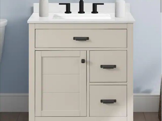 Lot 96-182087 - Home Decorators Collection
Stanhope 31 in. Single Sink Even Better Beige Bath Vanity with Carrara Wh...