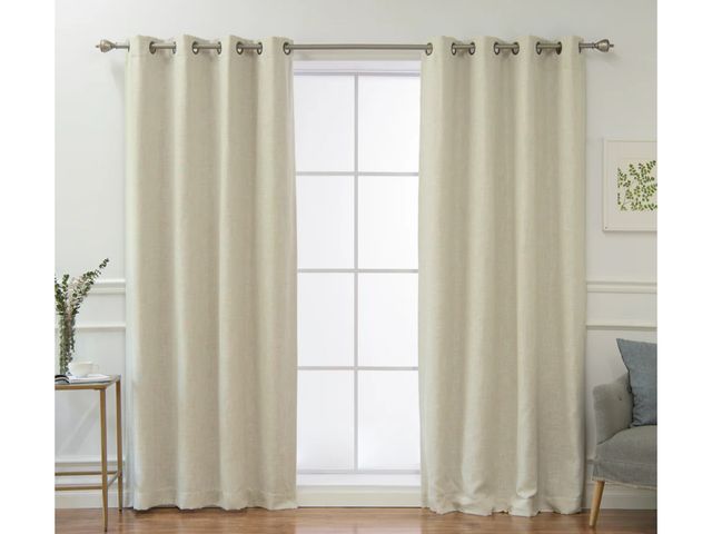 Lot 96-191300 - Two white grommet blackout curtain panels made of 100% polyester with a blackout lining, each measur...