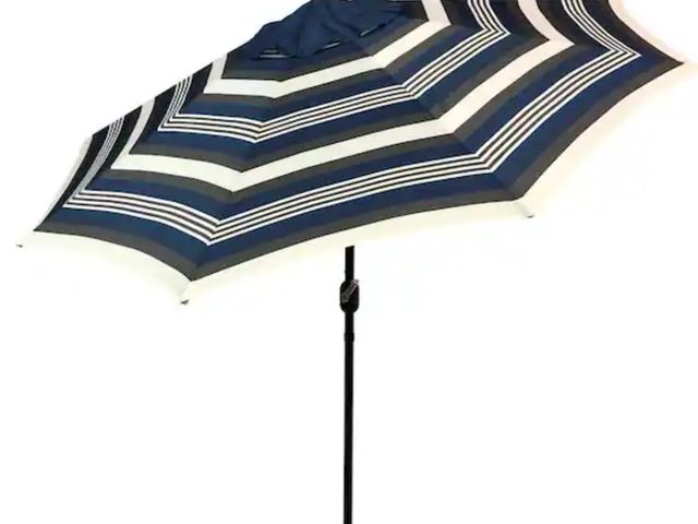Lot 96-232750 - Sun-Ray 9 ft. Steel Solar Lighted 8-Rib Round Market Patio Umbrella in Navy Striped Open box  Appear...