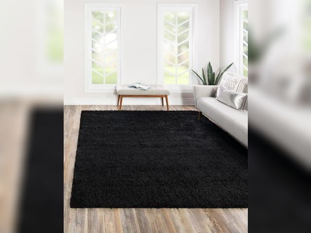 Lot 96-190642 - Large black shag area rug, dimensions unknown