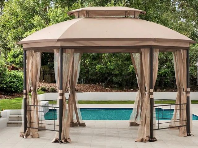 Lot 96-165798 - 12 ft. x 10 ft. Octagonal Steel Frame Gazebo with Tan Canopy
Open Box / Appears Unused 
Msrp $499.00