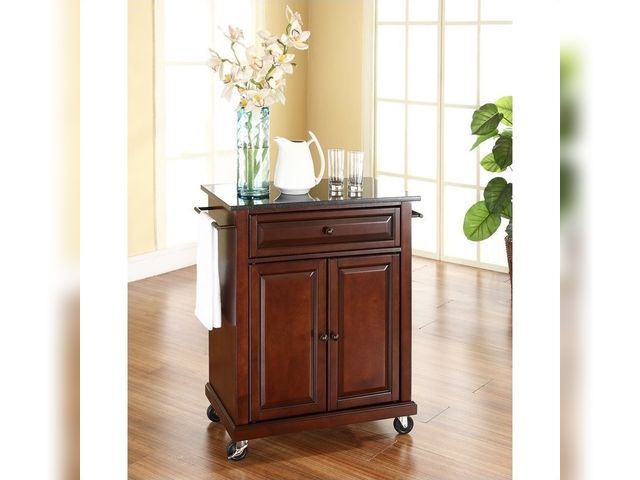 Lot 99-209 - New Crosley Furniture Wood Portable Kitchen Cart in Mahogany/Black  Save space while adding mobile s...